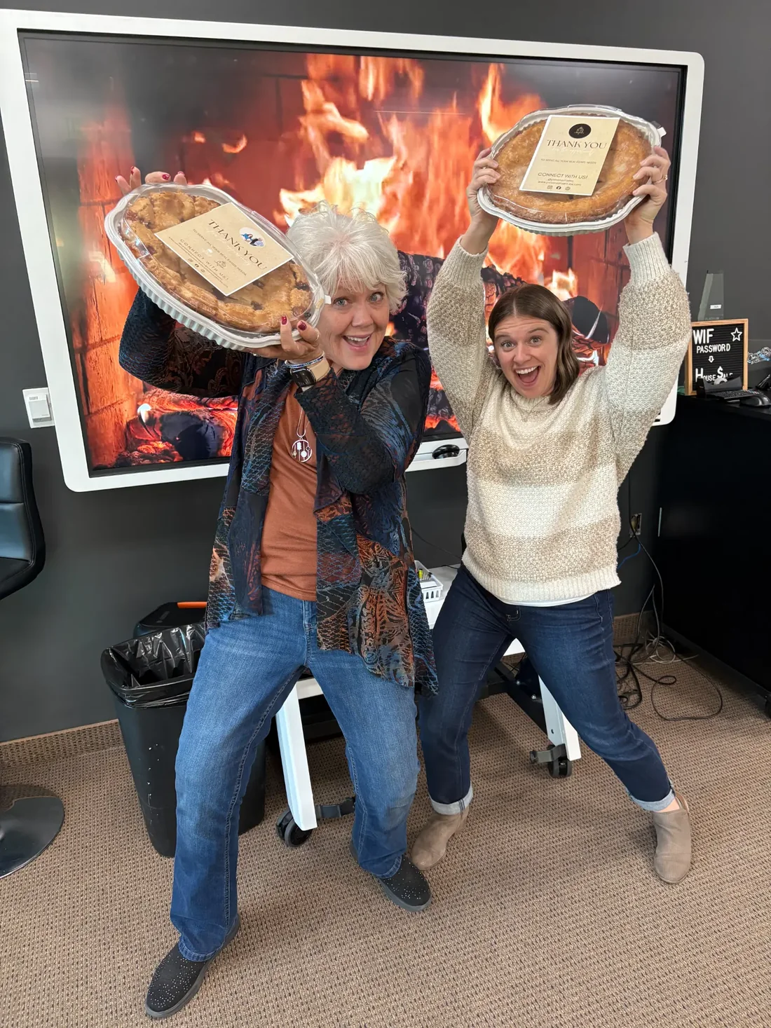 Yvonne Ethridge and Caroline Mathes holding up pies